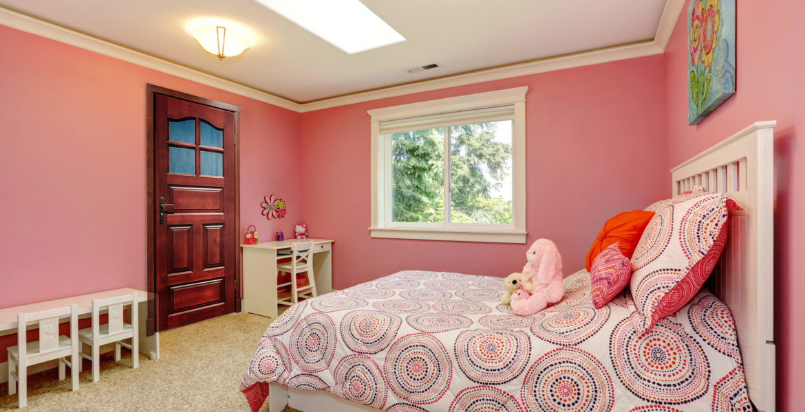Cozy and gentle colors bedroom for girls. Pink walls blend with bedding.