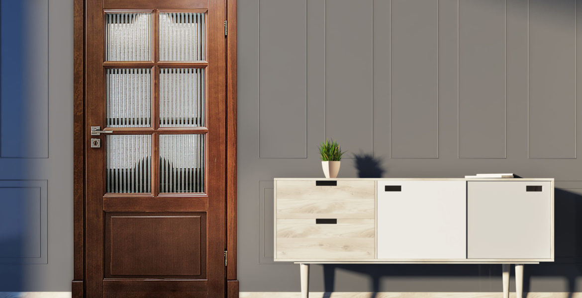 Gray living room interior with a chest of drawers, a potted plant and several book on it and a white and wooden door. 3d rendering mock up